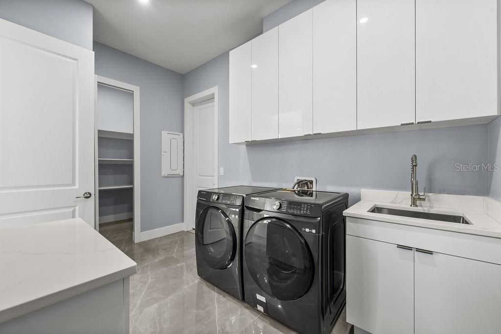 Laundry Room with Matching Front-Load Washer and Dryer ( Brand New) Walk -in Pantry on the left.