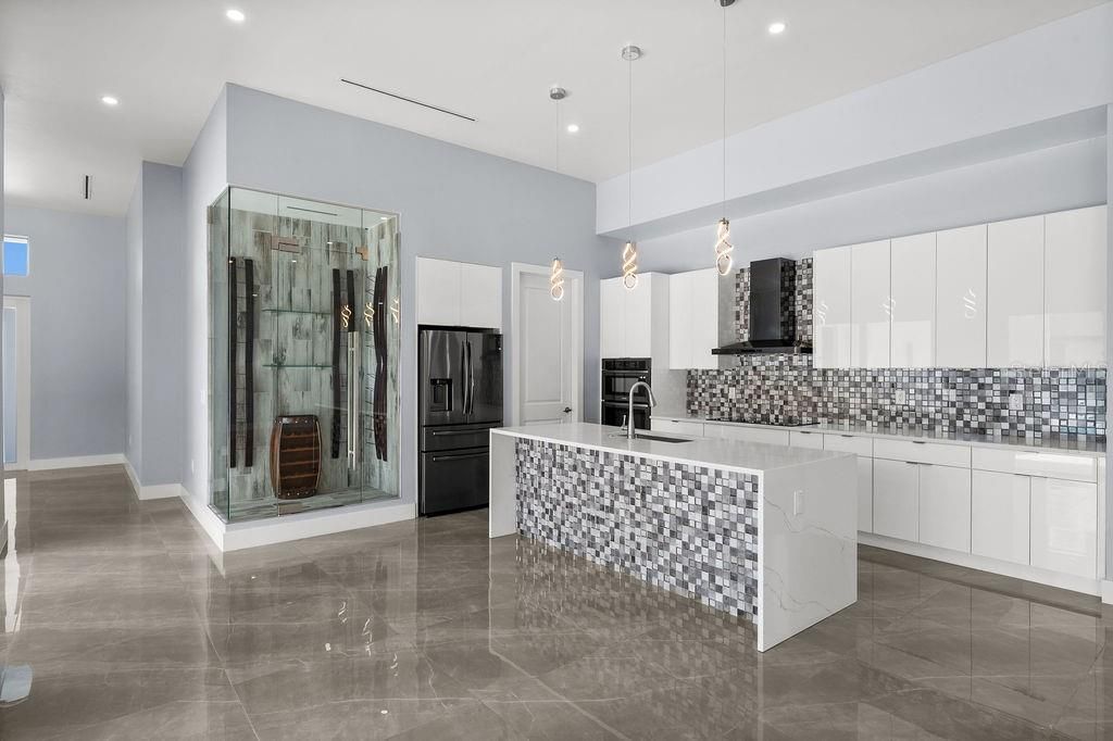 Kitchen with stainless steel appliances, quartz and wine room