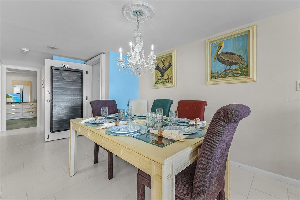 Tiled dining space featuring a chandelier