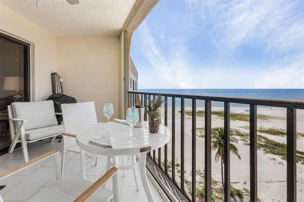 Balcony featuring a water view and a view of the beach from primary BR