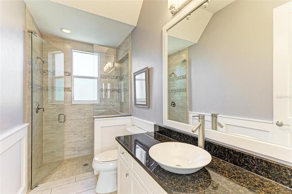 2nd Bathroom located on the first level, granite counters and walk in shower