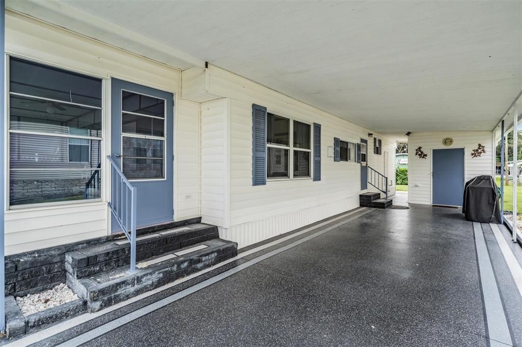 Large carport with painted driveway