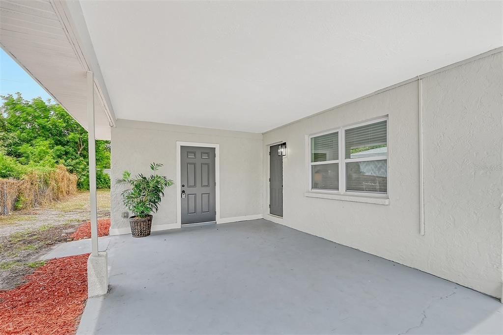 Carport with a Storage room that also houses Washer/Dryer