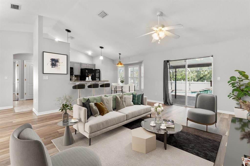 Living Room...Vaulted Ceiling, NEW Luxury Vinyl Planking & Slider to Screened Lanai w/ Pool...Virtually Staged