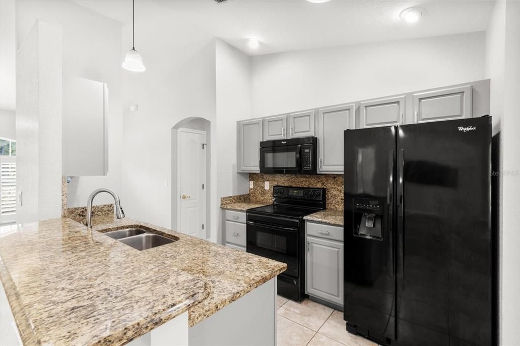 Kitchen w/ Granite Countertops & Backsplash, Breakfast Bar & Pantry Closet