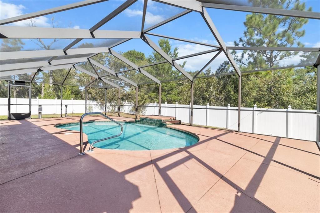 Screen Enclosed Lanai w/ Kidney Shaped Pool & Waterfall