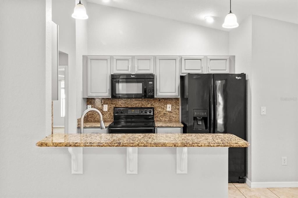 Kitchen w/ Granite Countertops & Backsplash, Breakfast Bar & Pantry Closet