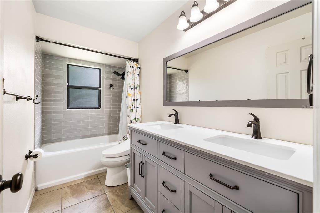 Hall Bath. New vanity, toilet & shower tile.