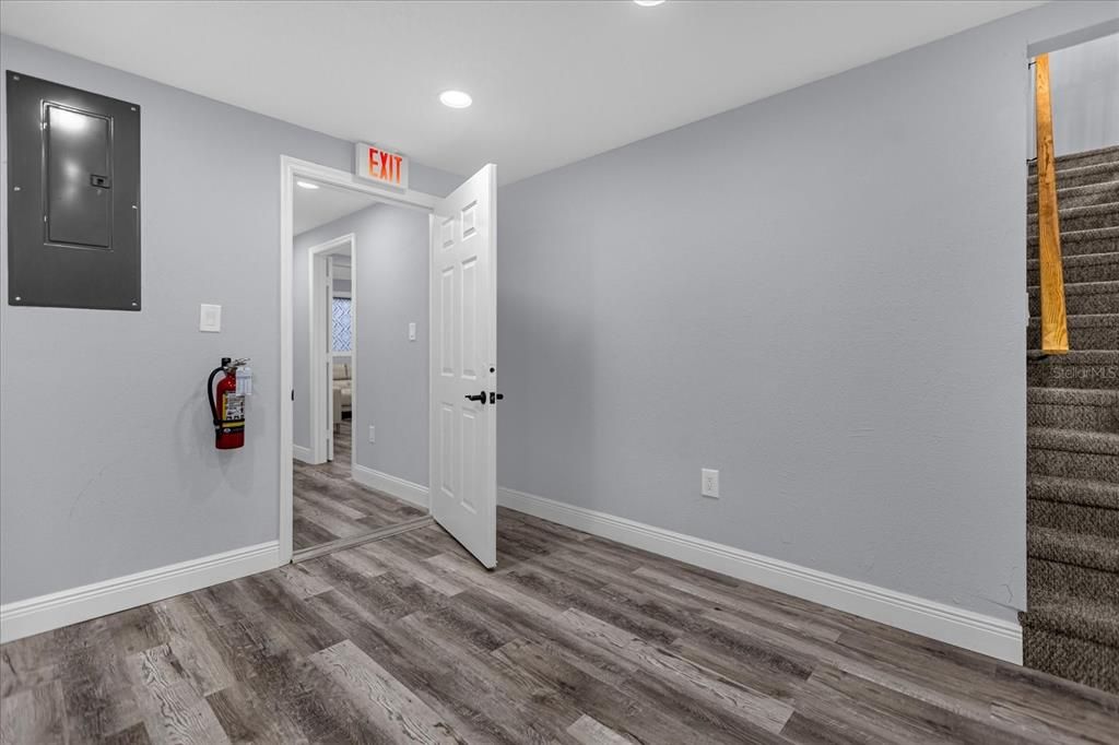 Stairs to upper level located near kitchenette