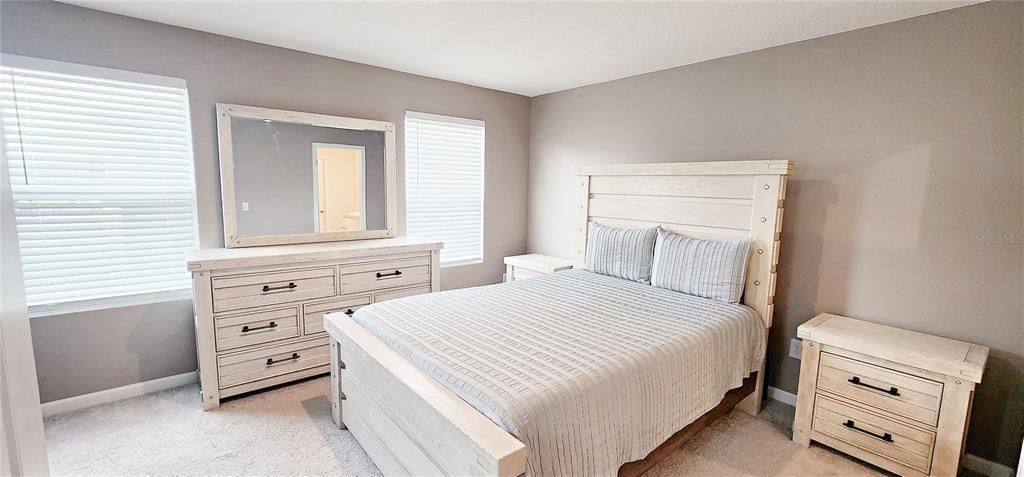 A good size main bedroom has extra windows since this townhome is an end unit.