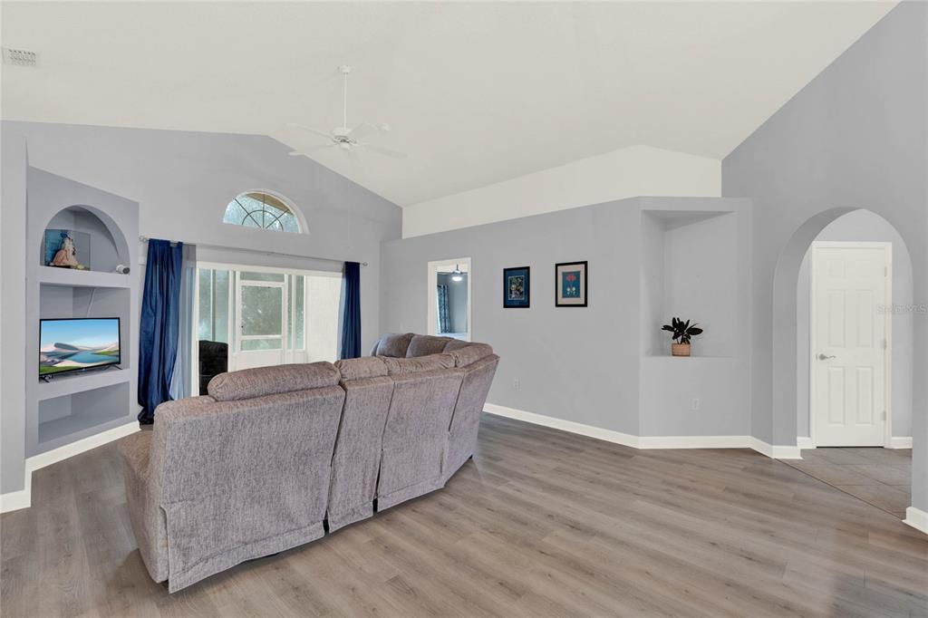 View of Living Room With Primary Suite Entry and Foyer Entry