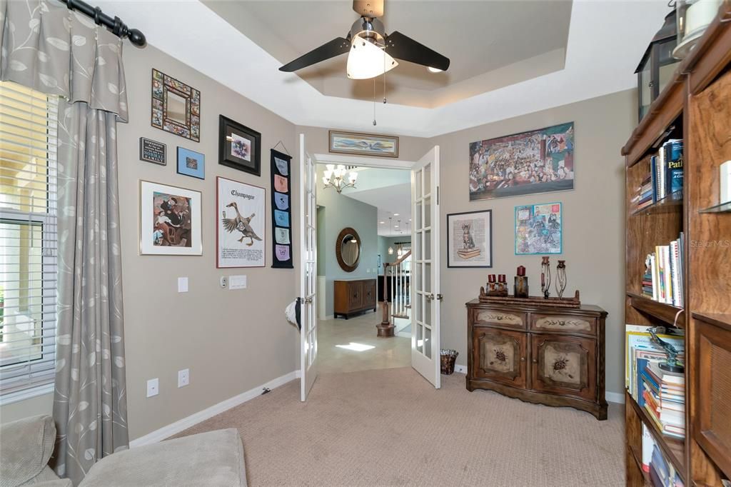 Front den/study, w/ stepped ceiling, & impact glass window