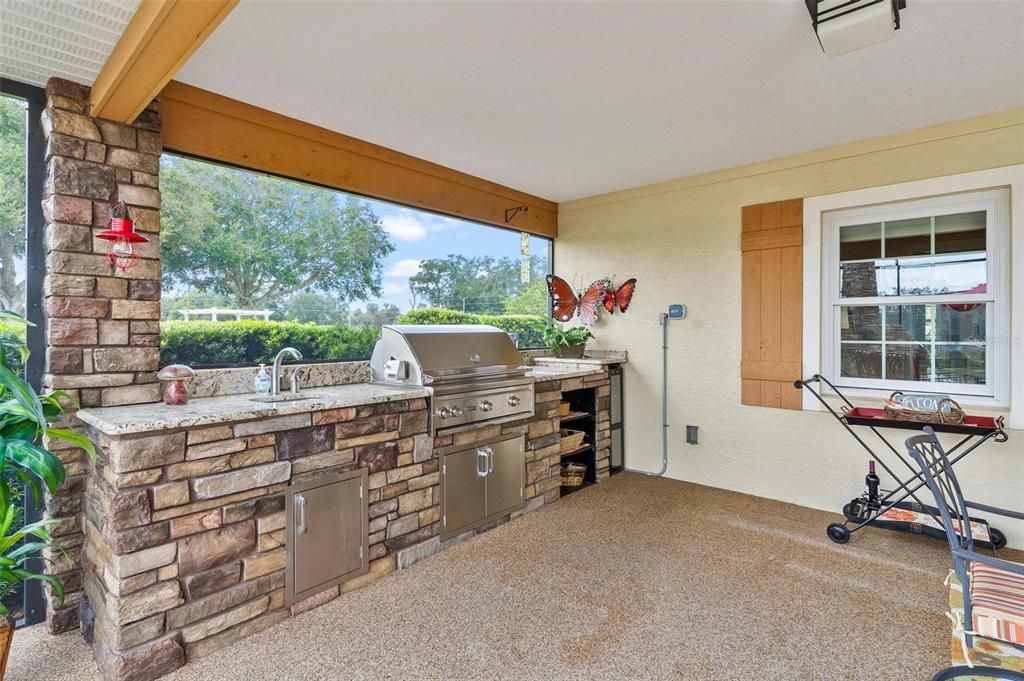 Outdoor Kitchen Area with Granite Countertops and Commercial Grade Grill