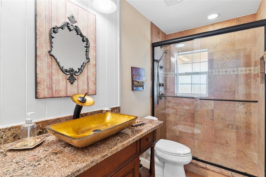 Beautifully Renovated Downstairs Guest Bath features Above Bowl Sink and Walk-in Shower