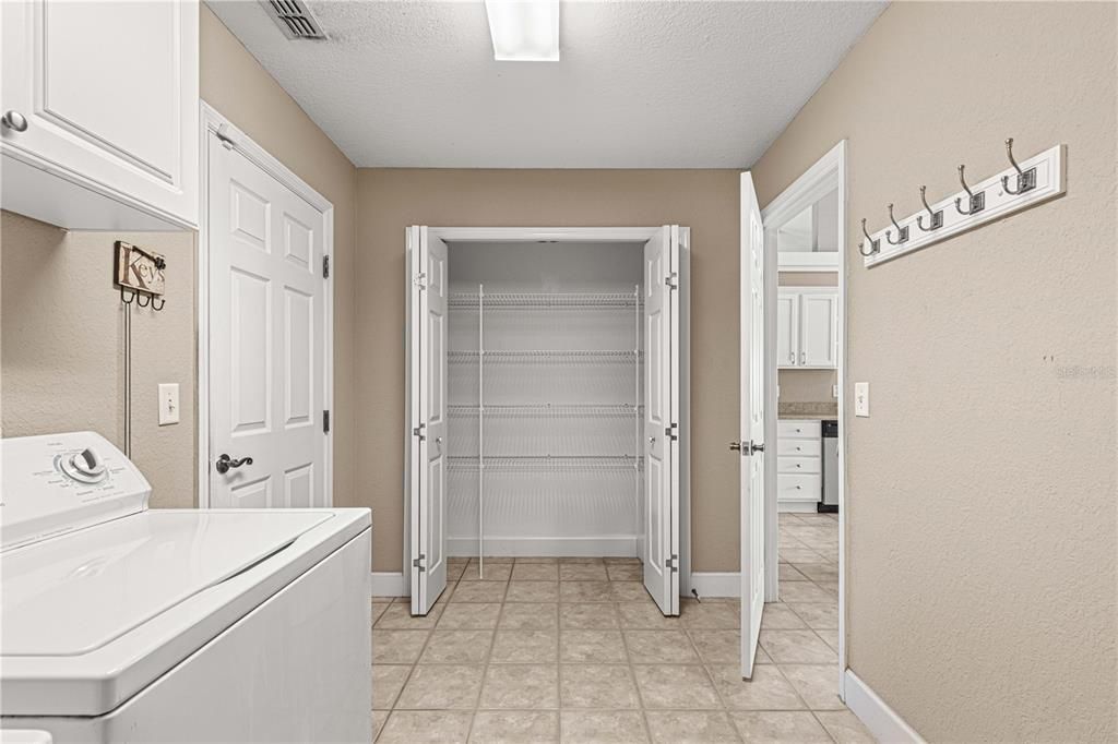 Laundry room includes a closet/pantry