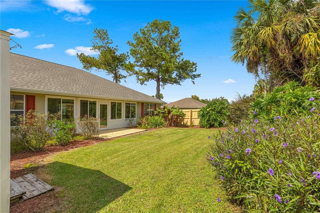 Fenced backyard with mature landscaping