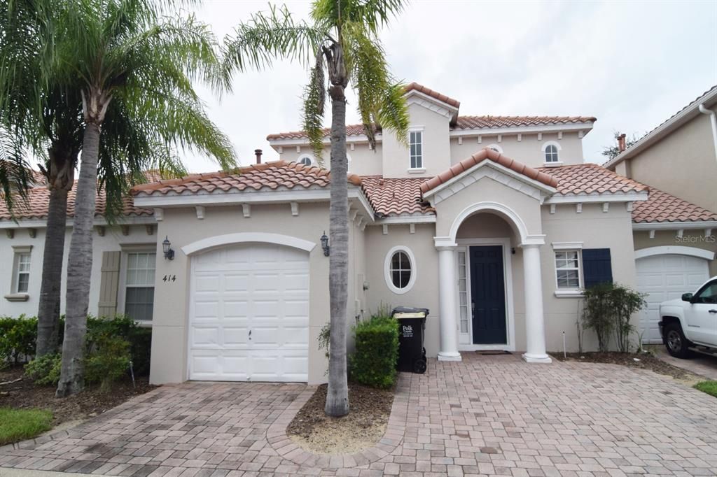 Front of home with paved driveway, garage