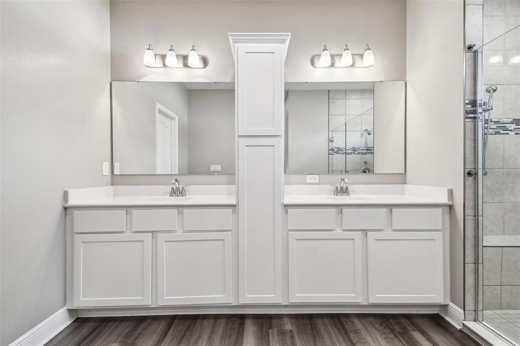 Primary bath. Luxurious double vanity. Double sinks. Quartz counters. Decorator light fixtures.