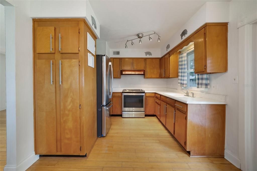 The family chef will appreciate a comfortable kitchen offering solid wood cabinetry for ample storage, STAINLESS STEEL APPLIANCES and a window over the sink that lets the light pour in.