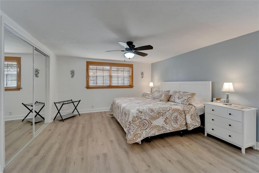 Primary bedroom has walk-in closet and built in closet with mirror doors