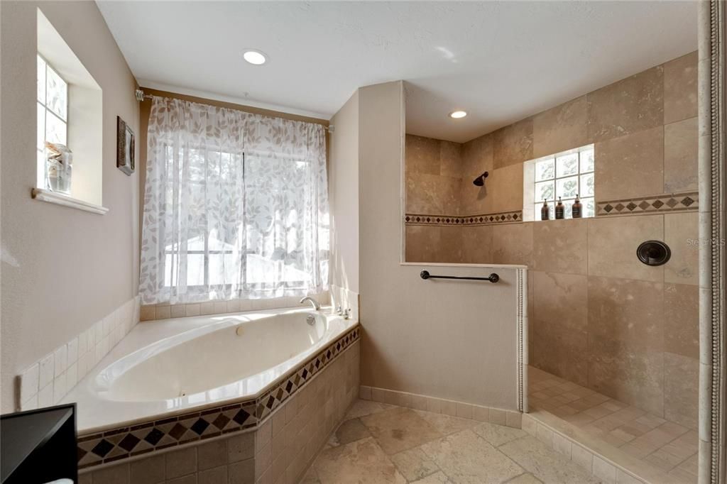 Delightful walk-in shower with decorative tile and separate - jetted garden tub