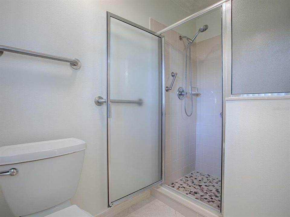 Primary Shower with Tile surround and stone look floor