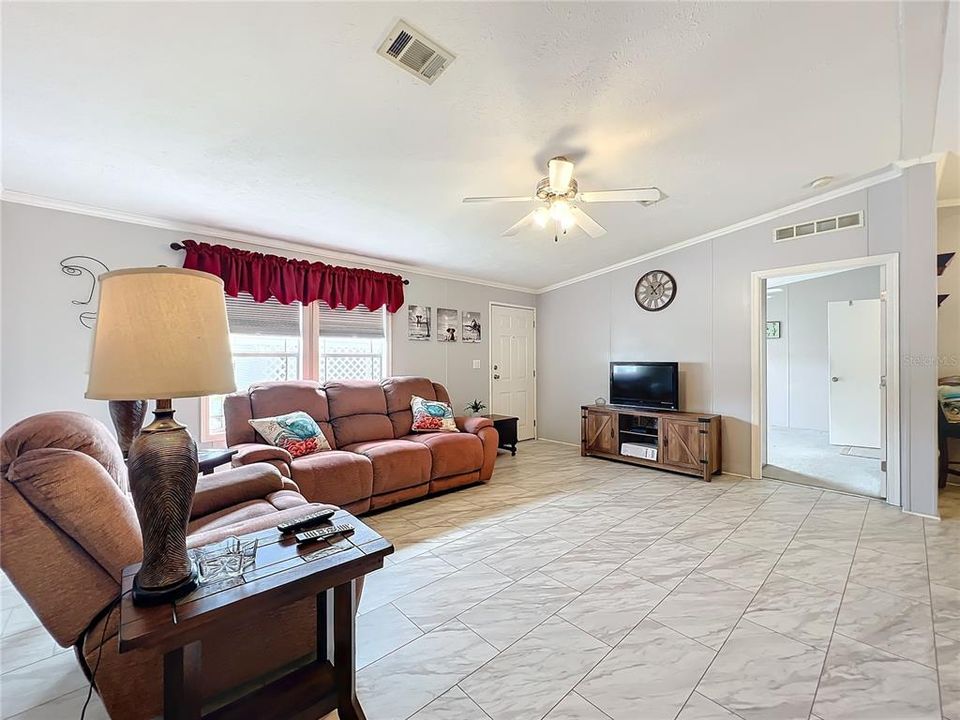 Living room and view into the primary bedroom