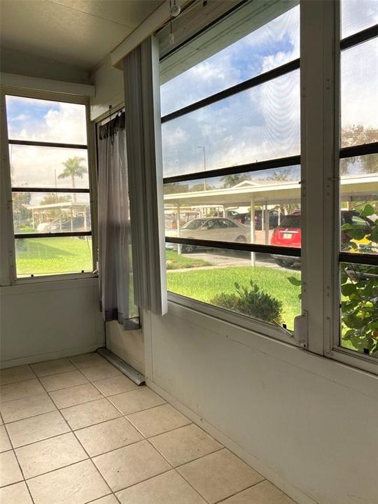 Lanai, with tile floor and jalousie windows.