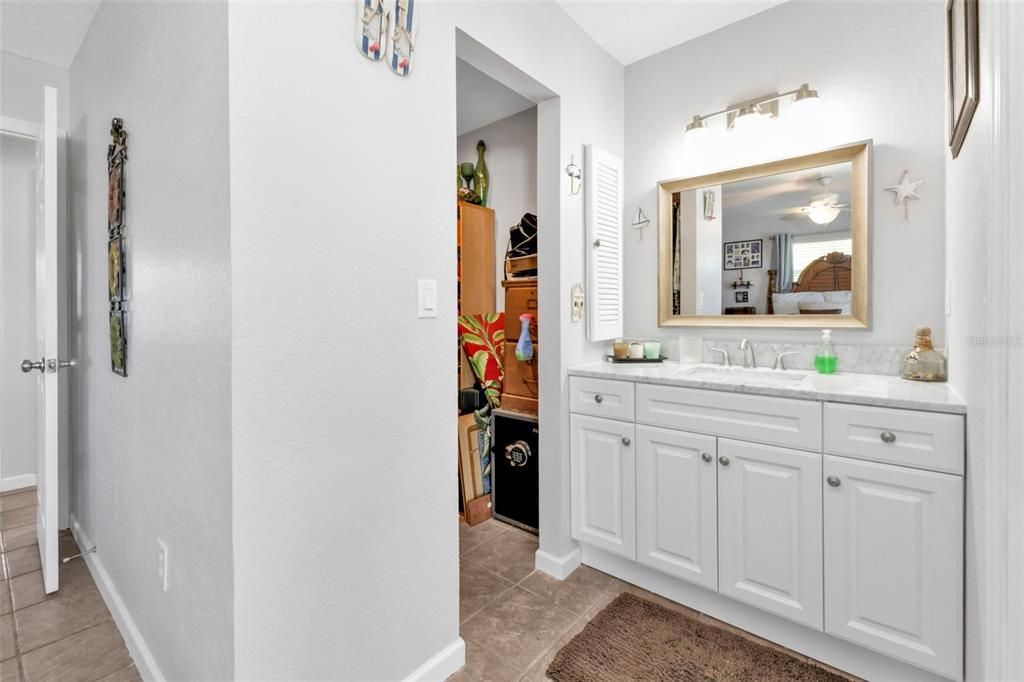 Master bathroom vanity with access to walk in closet.