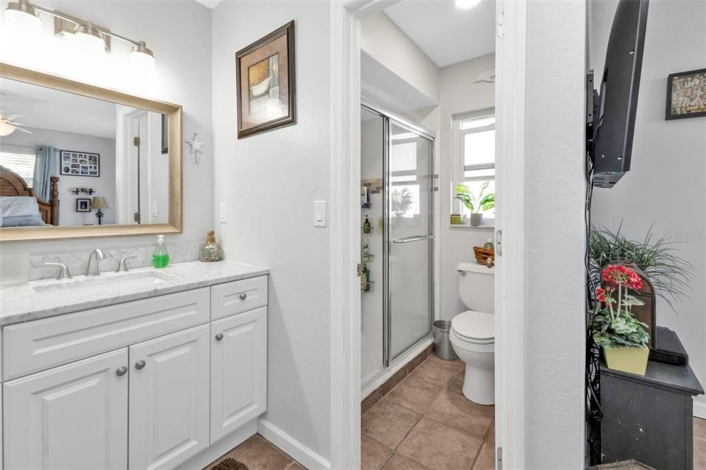 Master bathroom features single vanity and sink with walk in shower.