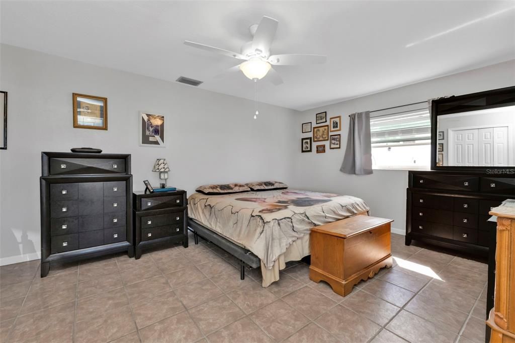 4th bedroom with tile flooring, closet and ceiling fan.