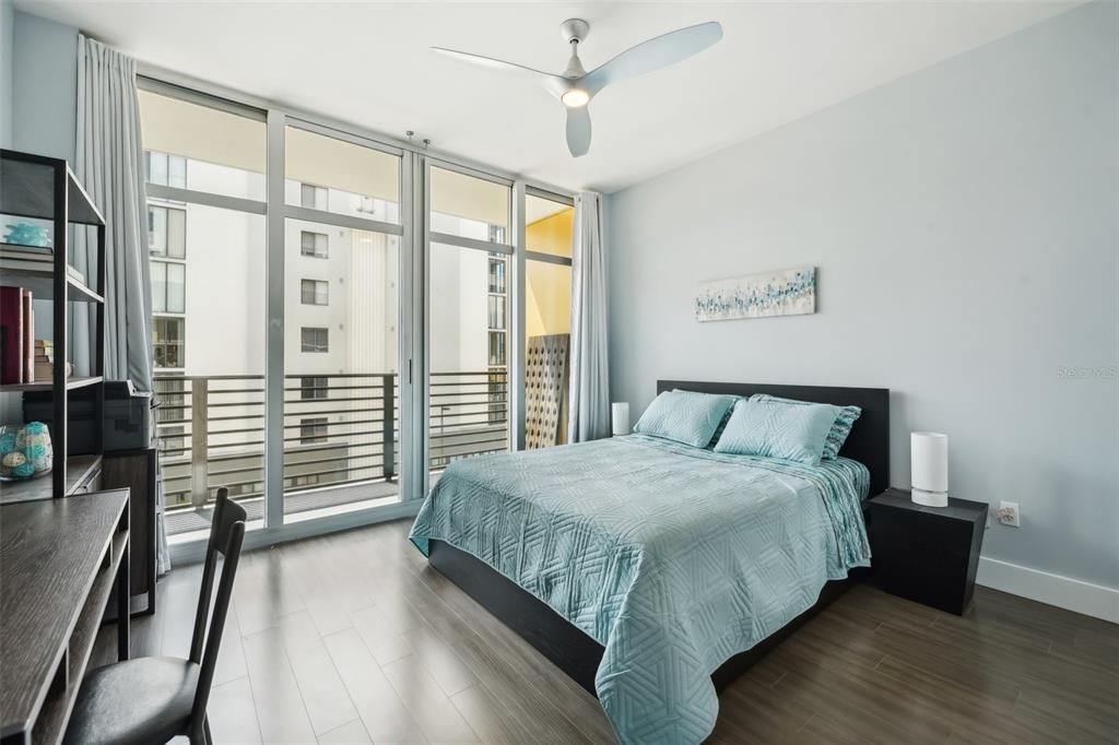 Guest bedroom is filled with natural light and has access to the balcony.