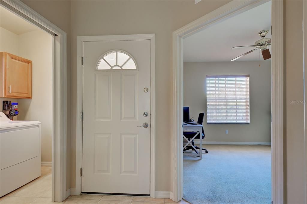 A view from the inside, including the laundry room and a guest bedroom.