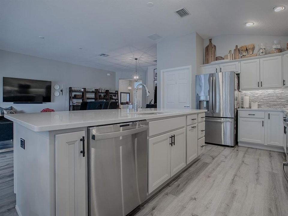 STAINLESS APPLIANCES! THE DOOR TO THE LEFT OF THE REFRIGERATOR LEADS TO THE LAUNDRY ROOM.