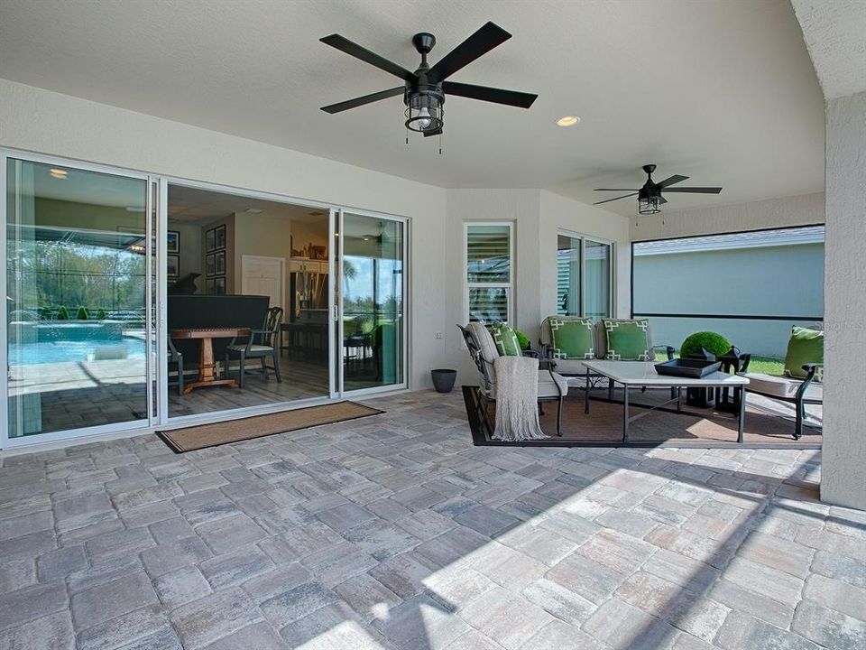 STEP OUT TO THE POOL AREA FROM THE LIVING ROOM AND/OR THE CASUAL DINING AREA.