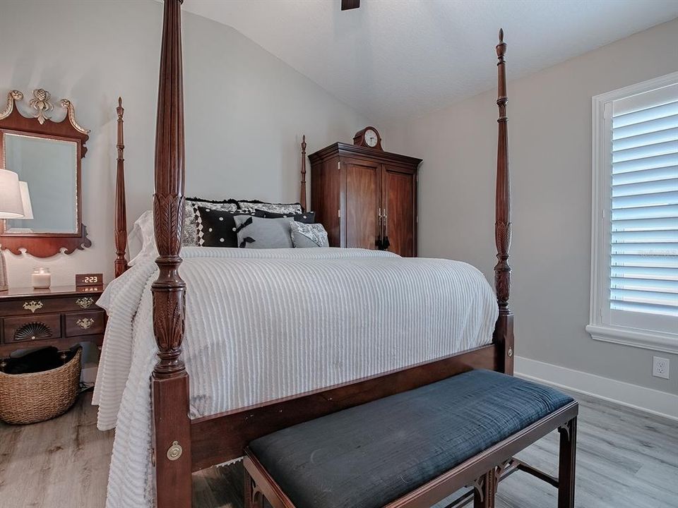 2ND GUEST ROOM WITH VAULTED CEILING, FAN, AND PLANTATION SHUTTERS.