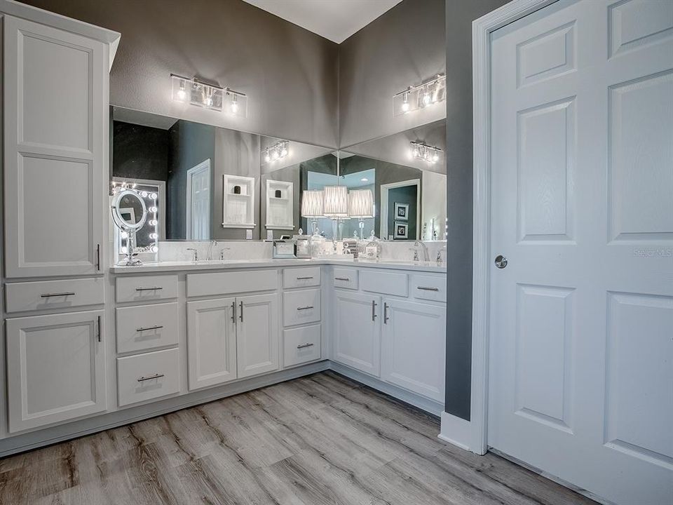 SPACIOUS WALK-IN CLOSET ON THE RIGHT WITH EXTRA RACKS AND SHELVING FOR ALL YOUR PERSONAL NEEDS. DUAL VANITIES WITH QUARTZ COUNTERTOPS.