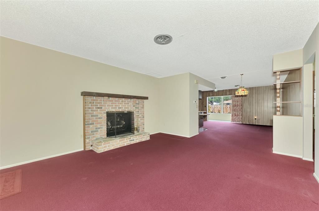 LIVING ROOM WITH BRICK WOOD-BURNING FIREPLACE (NOT WARRANTED)