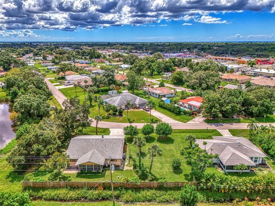 AERIAL OF HOMESITE (VACANT LAND ON RIGHT) + HOME ON LEFT