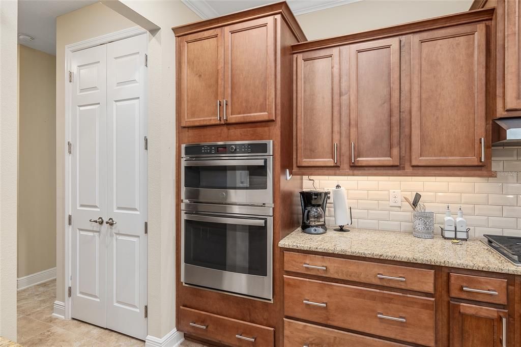 Built in oven and microwave next to pantry