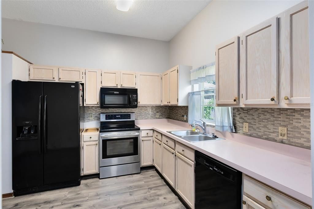 The eat-in kitchen boasts ample cabinet and counter space.