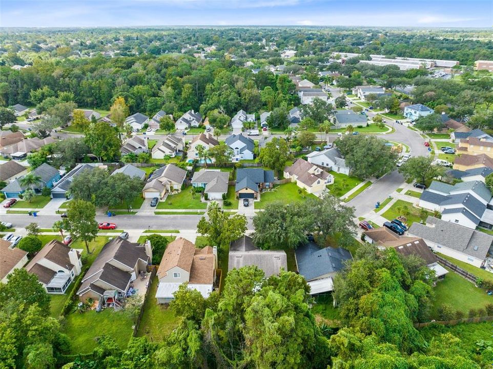 Aerial view of the rear of the home and surrounding neighborhood.