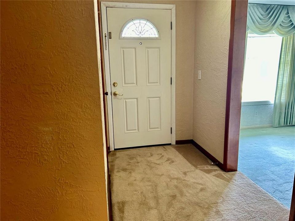 Entry door with step down access to the formal living /Dining and Den.