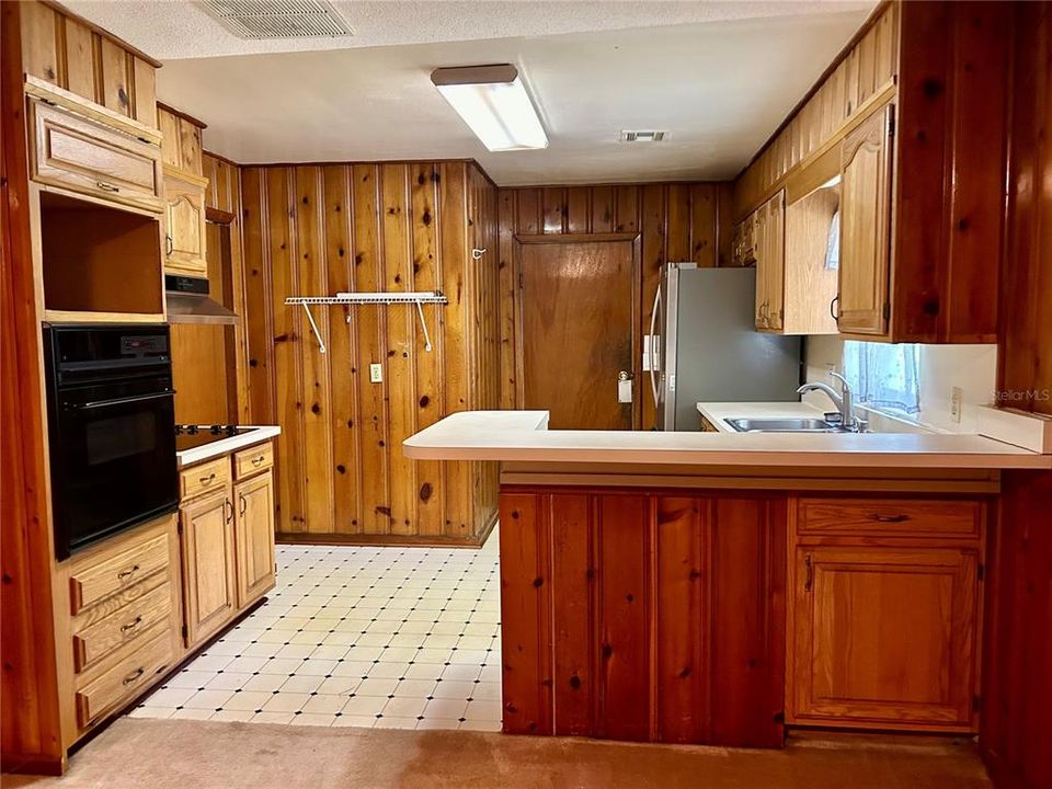 Kitchen. Door to utility room and one of the doors to outside.