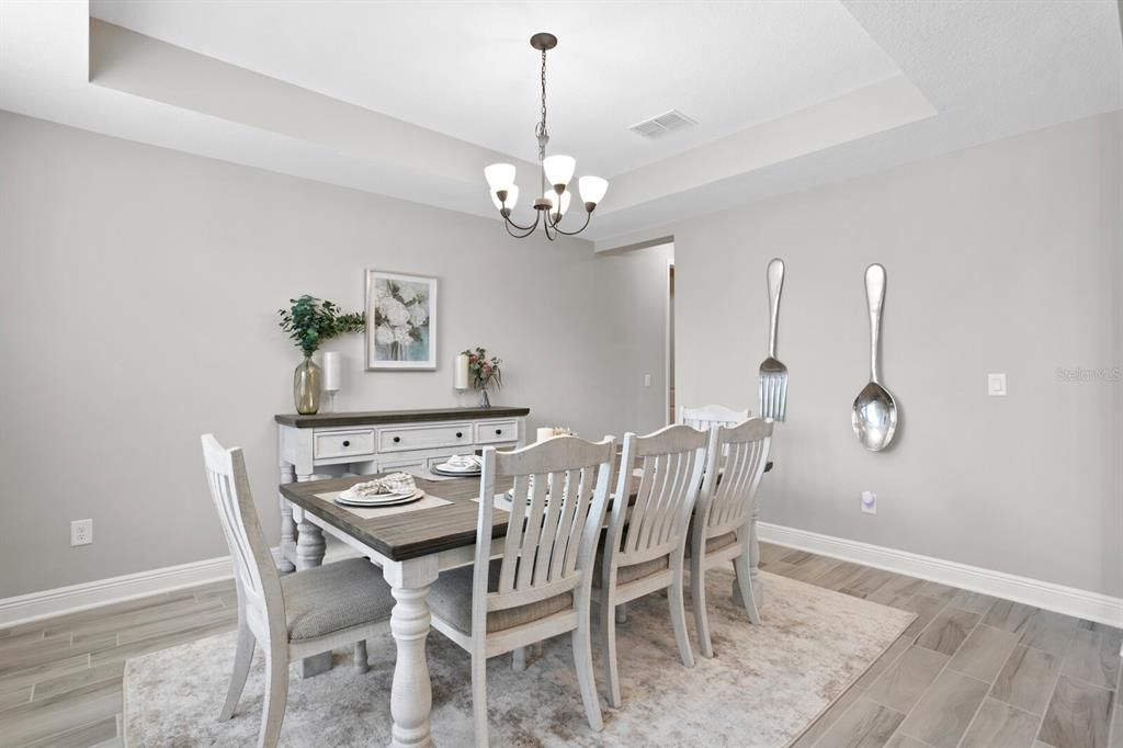 Overhead lighting and large windows with park view offers a perfect dining setting.