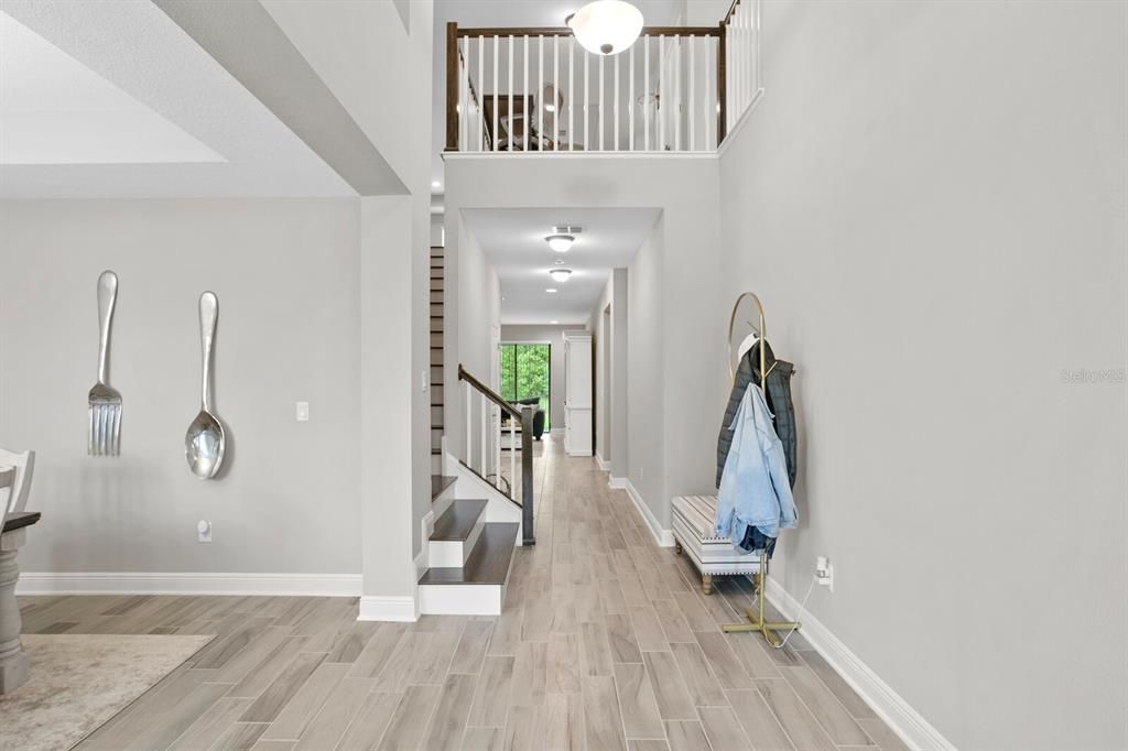 The entrance hallway leads you to the formal dining area and flex room.