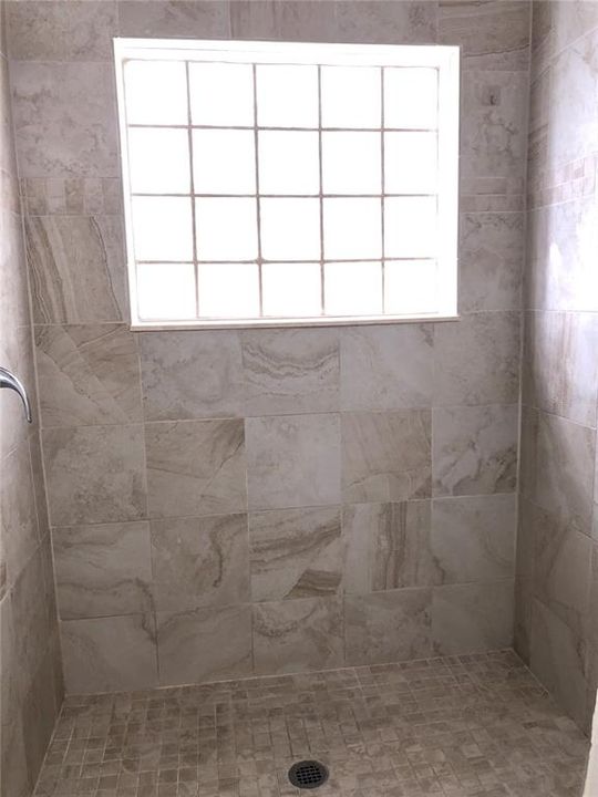 Primary Shower features Enhanced Tile.