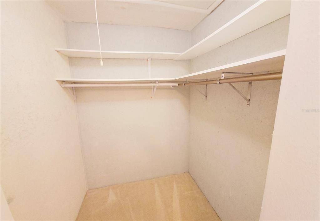 Large walk-in closet and pull-down attic door for storage.