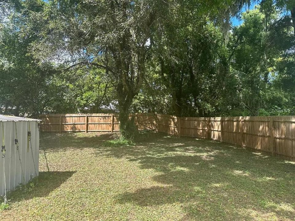 fully fenced yard with gate to the walking trail