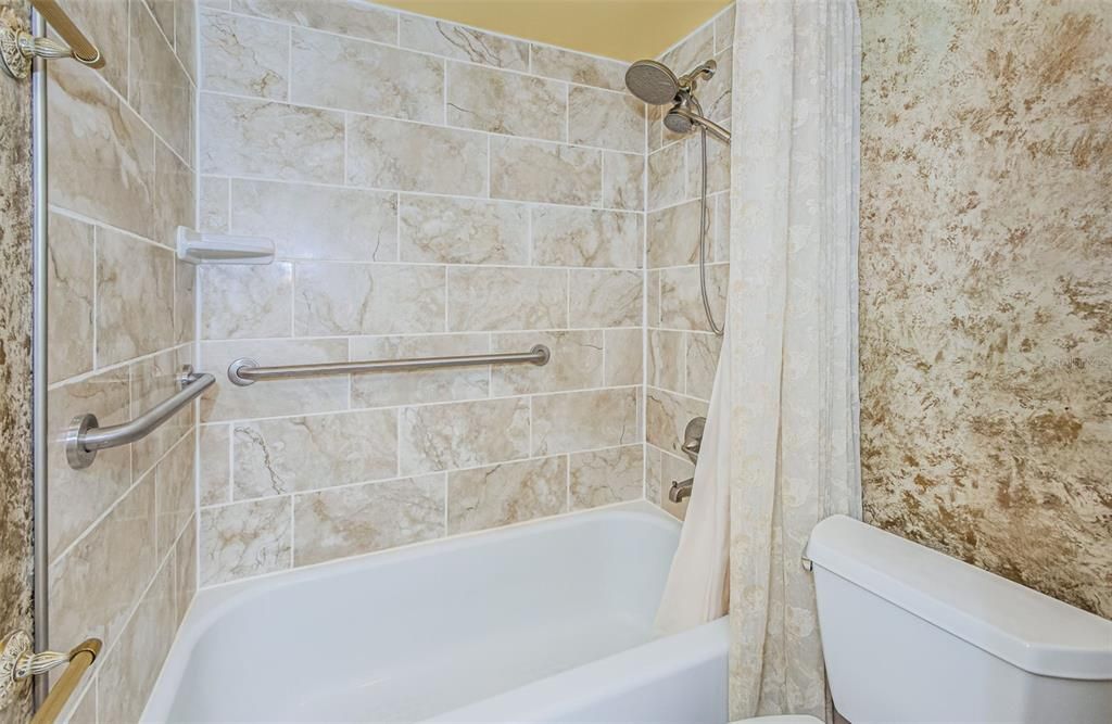 Tiled Shower with Grab Bars & Porcelain Tub